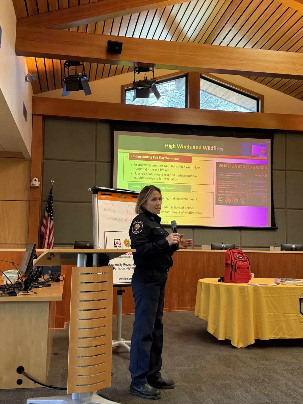 Fire Captain Denise Gluhan (retired) speaks in Town Hall